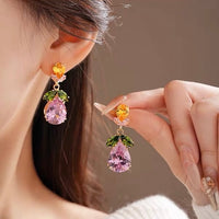 Secret Garden Crystal Jewelry Set featuring gold-plated brass with premium pink, green, yellow, and clear zirconia crystals in a botanical-inspired necklace and matching drop earrings.