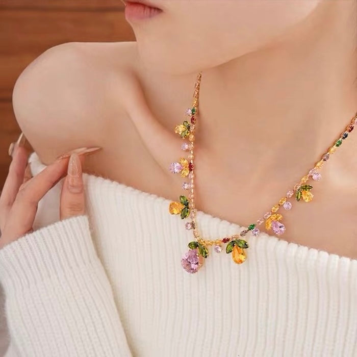 Secret Garden Crystal Jewelry Set featuring gold-plated brass with premium pink, green, yellow, and clear zirconia crystals in a botanical-inspired necklace and matching drop earrings.