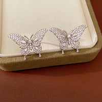 Enchanted Butterfly Ear Cuff in silver-plated brass featuring a butterfly silhouette with premium-grade zirconias, designed as an elegant ear cuff and sold as one pair.