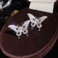 Enchanted Butterfly Ear Cuff in silver-plated brass featuring a butterfly silhouette with premium-grade zirconias, designed as an elegant ear cuff and sold as one pair.