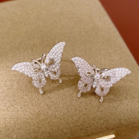 Enchanted Butterfly Ear Cuff in silver-plated brass featuring a butterfly silhouette with premium-grade zirconias, designed as an elegant ear cuff and sold as one pair.
