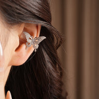 Enchanted Butterfly Ear Cuff in silver-plated brass featuring a butterfly silhouette with premium-grade zirconias, designed as an elegant ear cuff and sold as one pair.