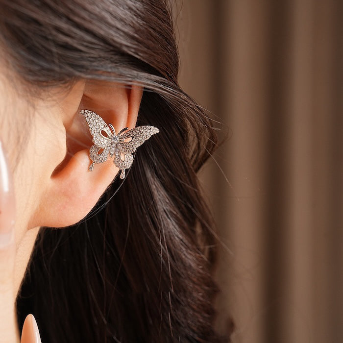Enchanted Butterfly Ear Cuff in silver-plated brass featuring a butterfly silhouette with premium-grade zirconias, designed as an elegant ear cuff and sold as one pair.