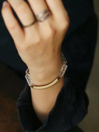 Clear Quartz Bar Bracelet featuring genuine clear quartz stone bars, bronze-toned findings, and a vintage-inspired charm.