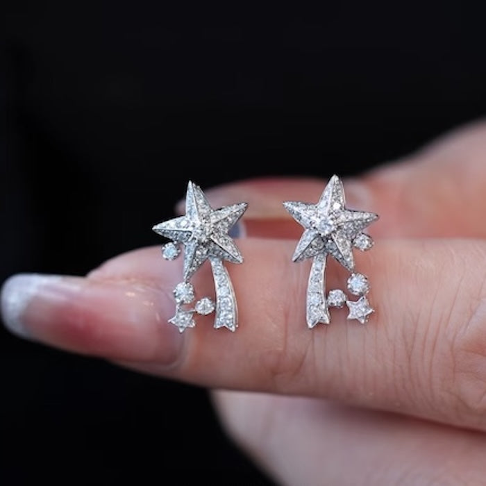 Radiant Starfall jewelry set featuring sparkling celestial star stud earrings and a matching adjustable ring crafted in white gold plated brass with premium grade zirconia.
