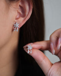 Radiant Starfall jewelry set featuring sparkling celestial star stud earrings and a matching adjustable ring crafted in white gold plated brass with premium grade zirconia.
