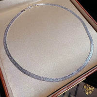 Ultra Shiny Layered Herringbone Chain Necklace featuring layered 7 mm herringbone chains with a highly polished finish in gold and silver-tone options.
