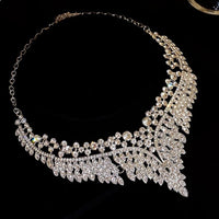 Grand Cascade Crystal Bridal Jewelry Set featuring a matching necklace and earrings with cascading marquise-cut premium-grade zirconia in a brilliant leaf-inspired design.