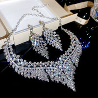 Grand Cascade Crystal Bridal Jewelry Set featuring a matching necklace and earrings with cascading marquise-cut premium-grade zirconia in a brilliant leaf-inspired design.