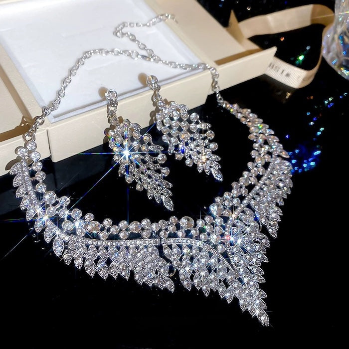 Grand Cascade Crystal Bridal Jewelry Set featuring a matching necklace and earrings with cascading marquise-cut premium-grade zirconia in a brilliant leaf-inspired design.