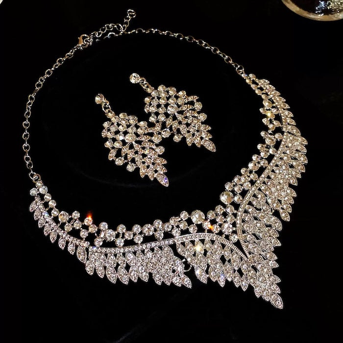 Grand Cascade Crystal Bridal Jewelry Set featuring a matching necklace and earrings with cascading marquise-cut premium-grade zirconia in a brilliant leaf-inspired design.