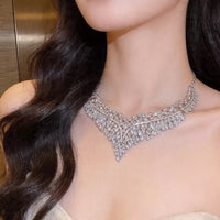Grand Cascade Crystal Bridal Jewelry Set featuring a matching necklace and earrings with cascading marquise-cut premium-grade zirconia in a brilliant leaf-inspired design.