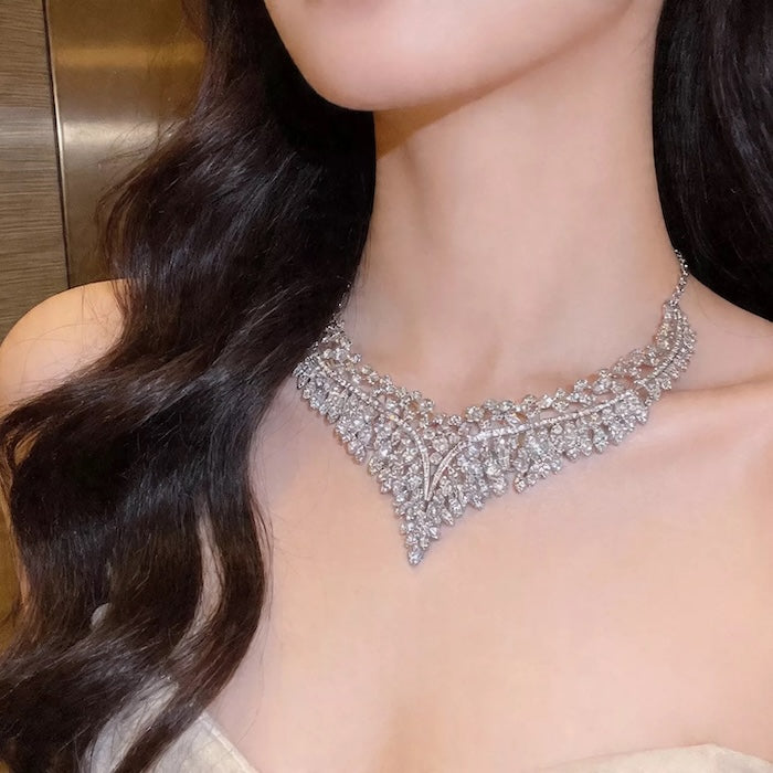 Grand Cascade Crystal Bridal Jewelry Set featuring a matching necklace and earrings with cascading marquise-cut premium-grade zirconia in a brilliant leaf-inspired design.