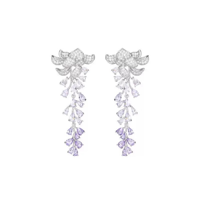 Dazzling Wisteria Flower Tassel Earrings featuring sparkling floral zirconia details and cascading lavender-toned crystal tassels in a silver-tone setting.
