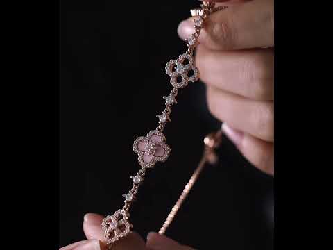 Blooming Clover Charm Bracelet featuring clover blossom charms accented with sparkling stones and an adjustable slider clasp.