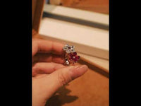 Ruby Plum Blossom Ring featuring ruby-colored and clear crystal plum blossoms on a white gold-plated adjustable band.