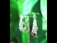 Emerald Ribbon Cascade Earrings with an emerald green teardrop crystal, silver-plated finish, sparkling zirconia, ribbon-inspired detailing, and crystal tassels.
